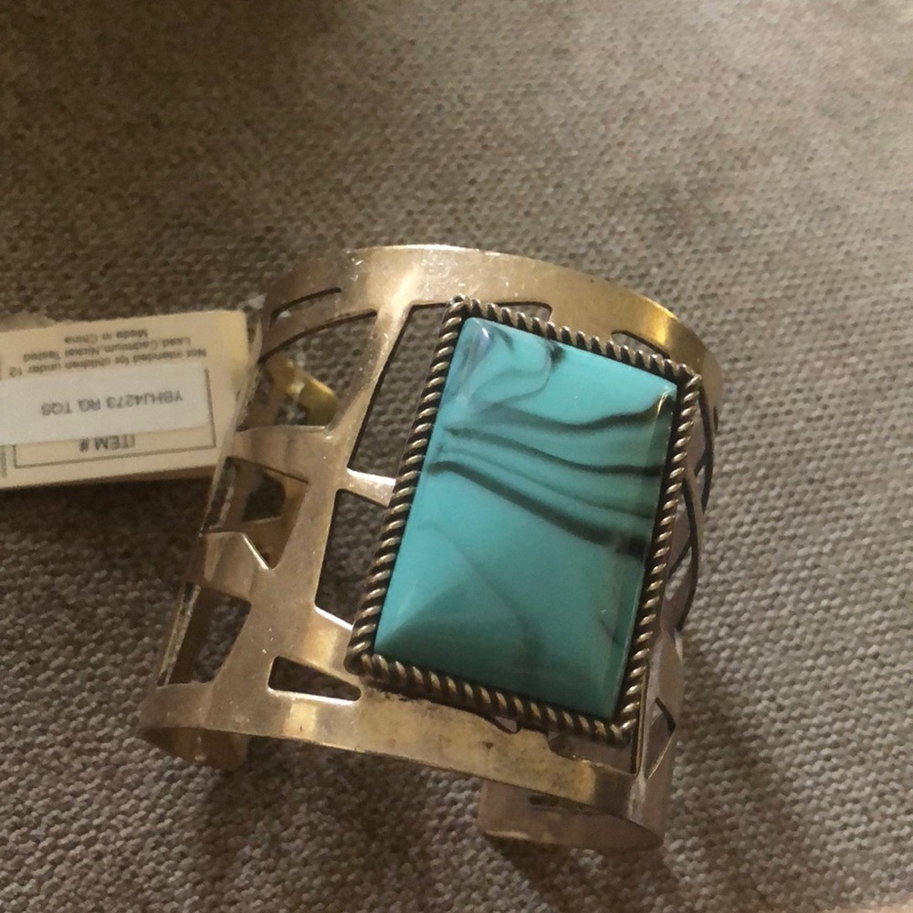 Braclets with costume jewelry turquoise stone. Gold band.